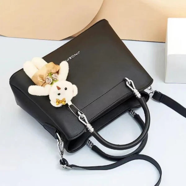 Women's Black Casual Large Capacity Handbag with Bear Pendant Double Handle Zipper Closure Synthetic Leather Exterior and Polyester Interior. - Shop N Save