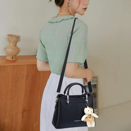 Women's Black Casual Large Capacity Handbag with Bear Pendant Double Handle Zipper Closure Synthetic Leather Exterior and Polyester Interior. - Shop N Save