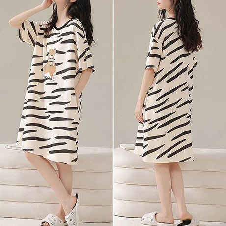 Stay Comfy and Stylish with our Striped Print Midi Night Dress! Perfect for Lounging at Home or Getting a Good Night's Sleep. Available in Black with Short Sleeves and a Loose Fit. Made from Terylene and Cotton Blends. Must-Have for Women!